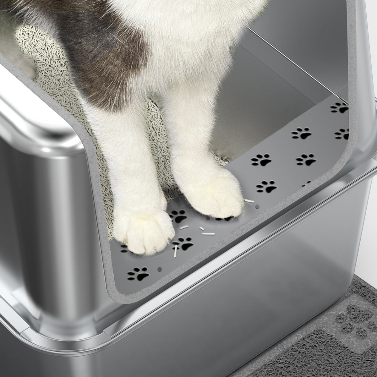 High-sided stainless steel litter box shown with a cat inside